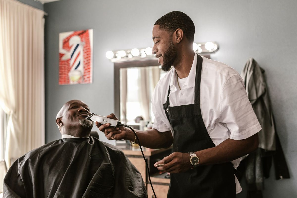 Barber giving a customer a careful beard trim
