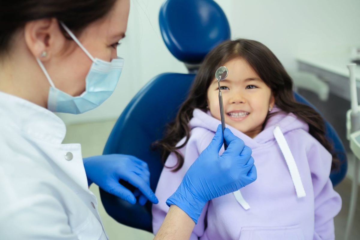 Smiling child with a dentist during a check-up