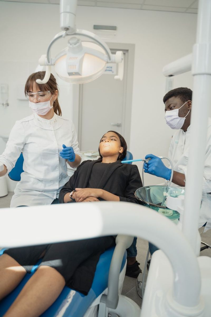 Dental professionals caring for a patient in a clinic